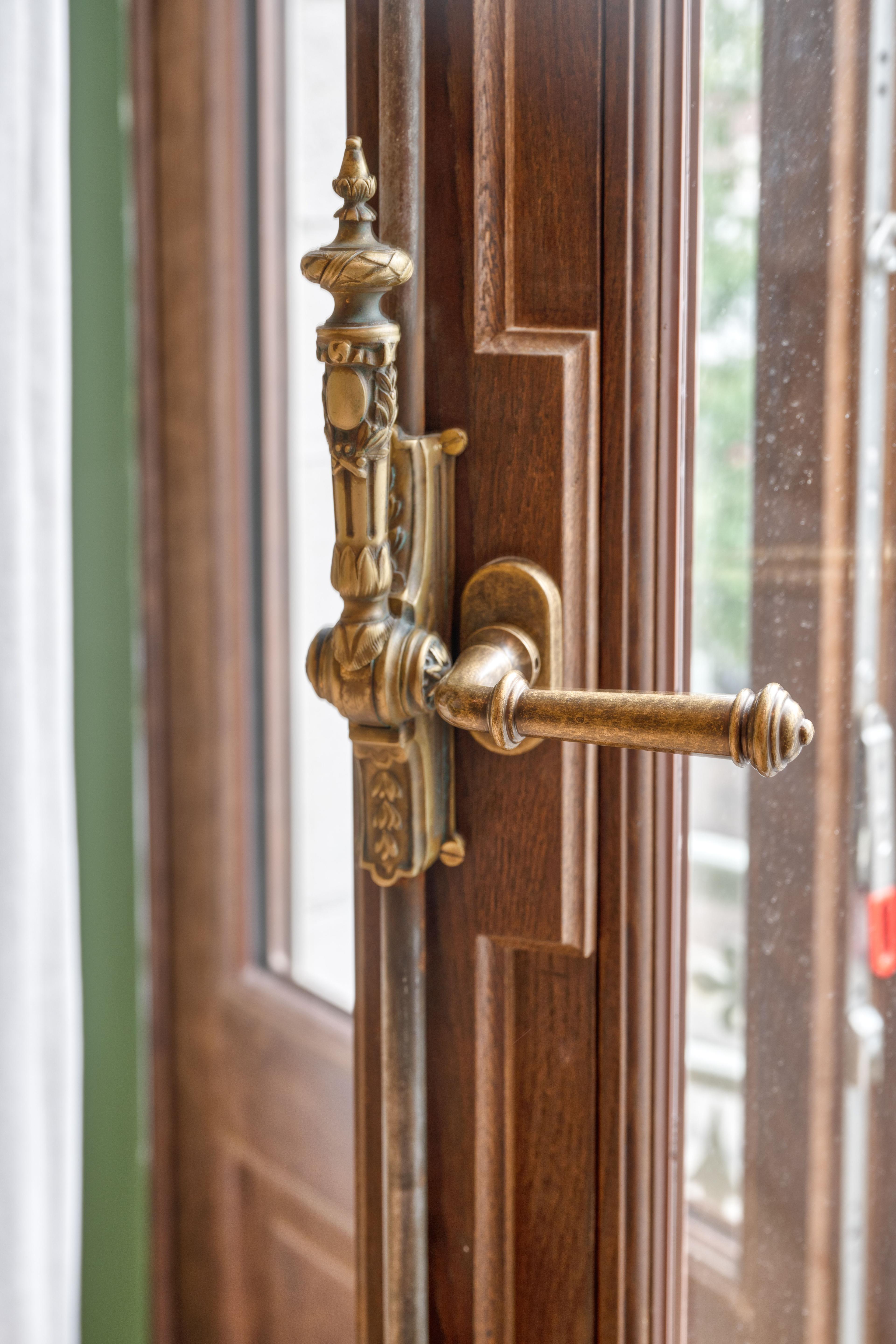 Sierlijke koperkleurige kruk op een houten raamkader, in een appartement van het project Belfortstraat 29 – Onderstraat 75A in Gent.